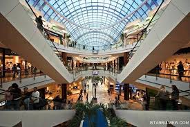 Architectural lighting installation in a modern shopping mall atrium.
