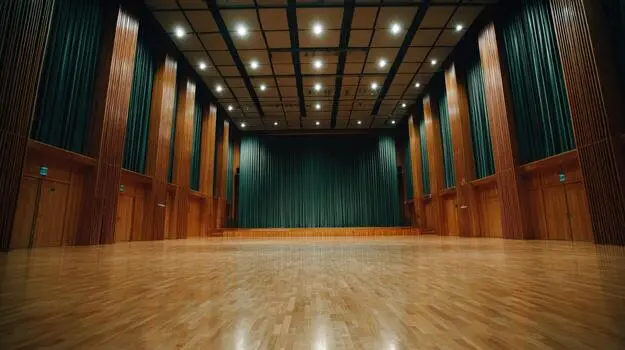 Indoor sports hall featuring LED scoreboards, PA audio system and lighting integration